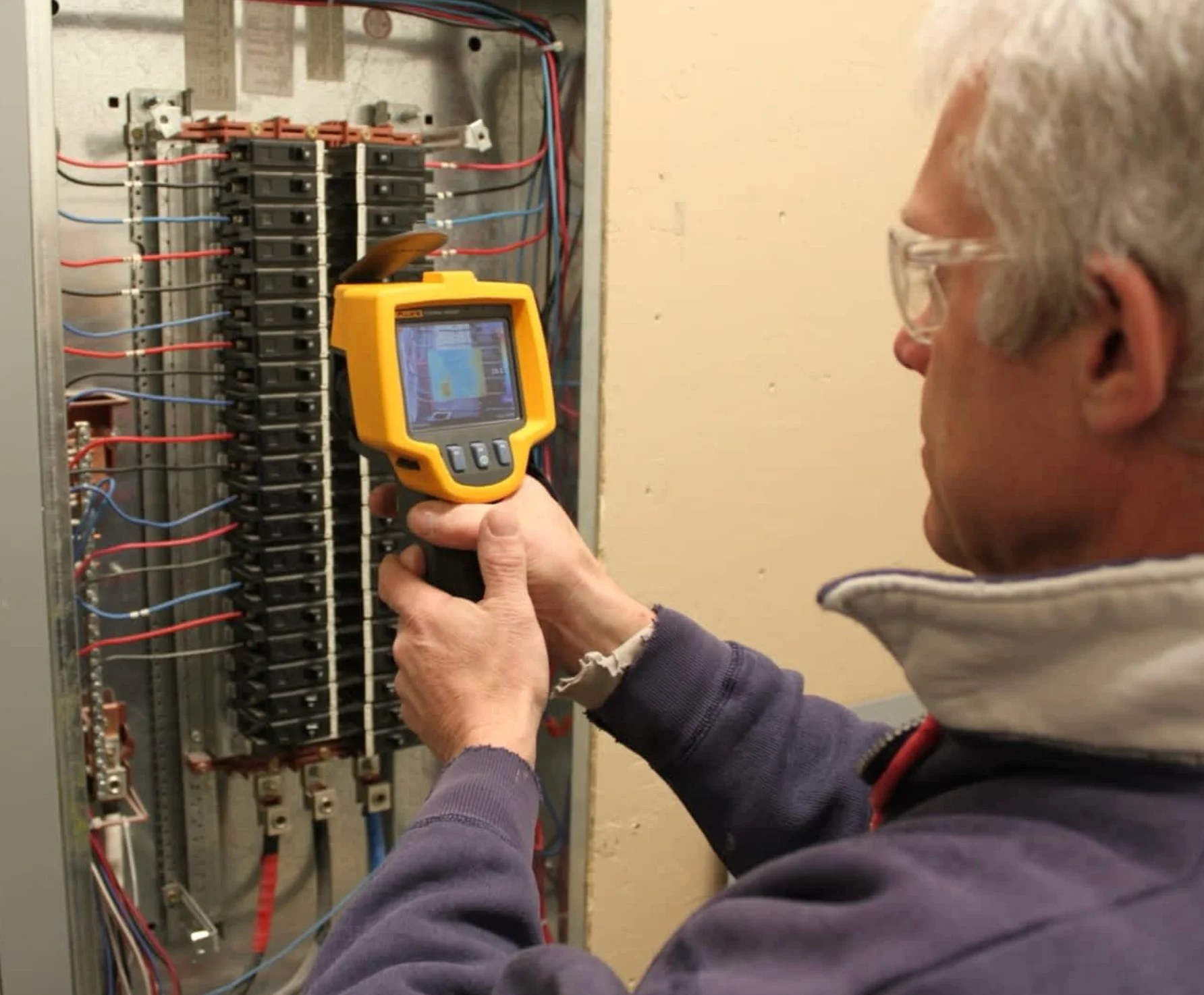 Wayne using a Fluke thermal-imaging camera to inspect an electrical panel