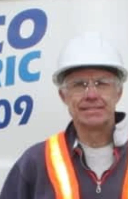 Wayne Cote, owner of Wayco Electric, in a hard hat and hi-vis vest